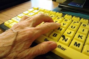 Hand on high contrast accessible computer keyboard